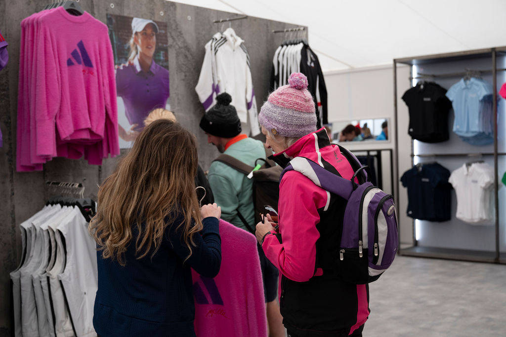 Fans browse the shop at the AIG Women's Open fan village.